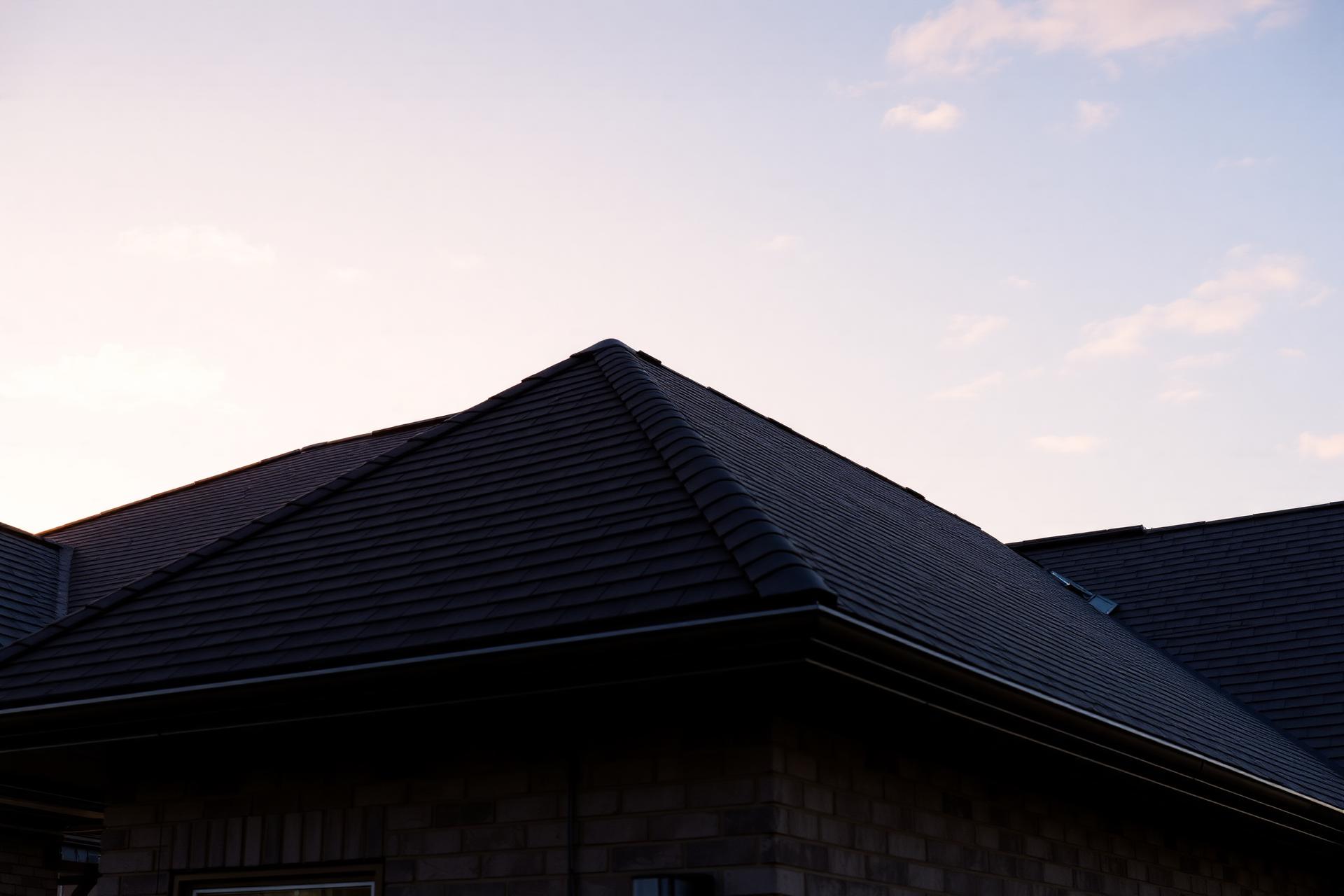 Premium asphalt shingle roof at golden hour in Greater Houston